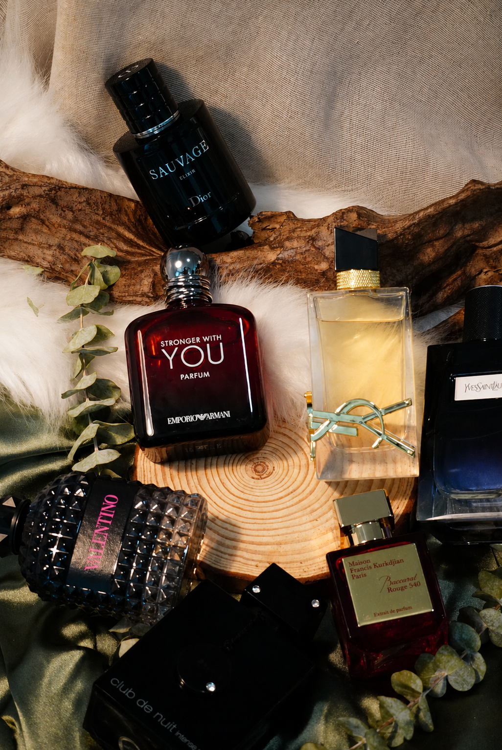 Dark perfume bottle resting on a sunlit desert dune